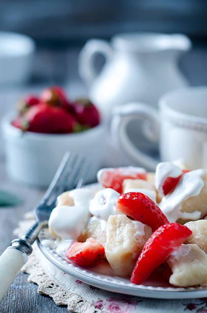 istock Cottage cheese dumplings with strawberries on background top view 534678766