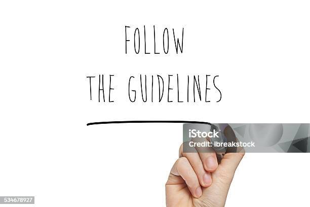 Hand Writing Follow The Guidelines Stock Photo - Download Image Now - Instructions, Following - Moving Activity, Guidance