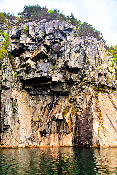 istock Carved rock stretches vertically in the sea 534679725
