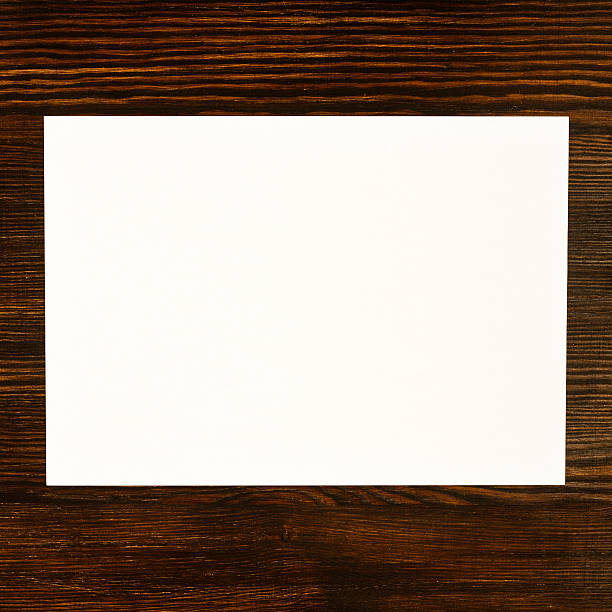 istock White paper card on wooden desk background 534680611