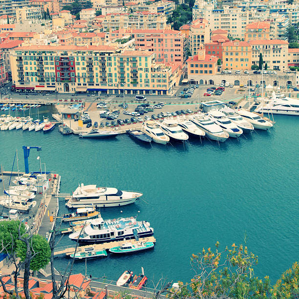 Panoramic view of Nice (Cote d'Azur, France) with harbor, yachts and beautiful buildings. View from above, square toned image, instagram effect