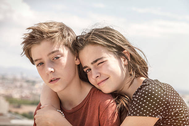 istock sister hugging her brother, toned image 534683767