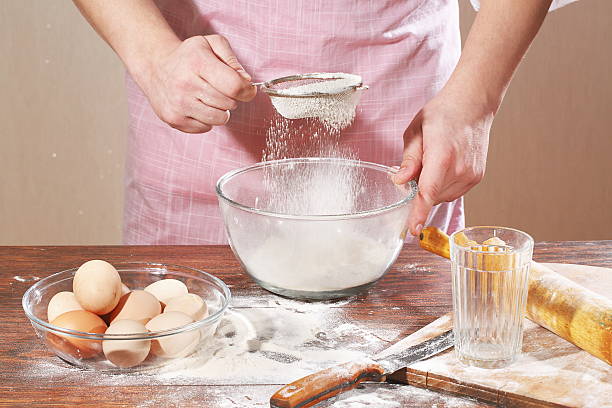 istock Man's hand holding a sieve for sifting flour 534684563
