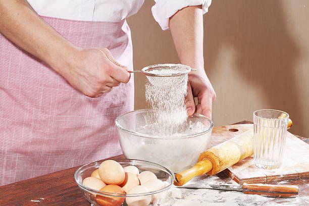 istock Man's hand holding a sieve for sifting flour 534684565