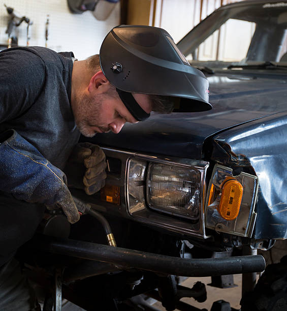 istock Man with welding tool in front of truck 534697011