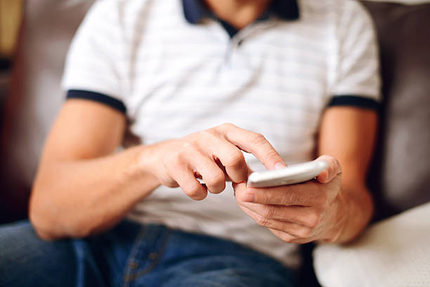 istock male hand holding a smartphone closeup 534699959