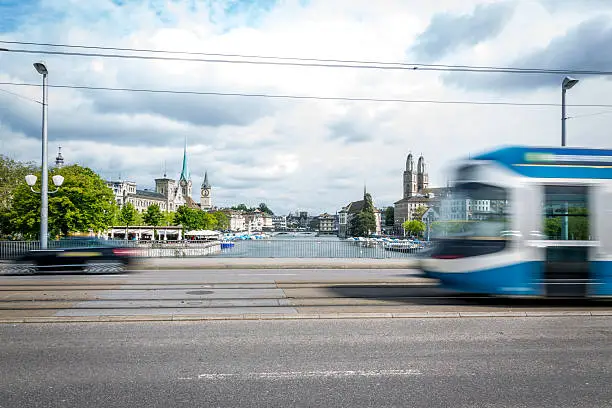 A tram passing by the city center of Zurich in Switzerland. The tram is blurred due to motion and long exposure.