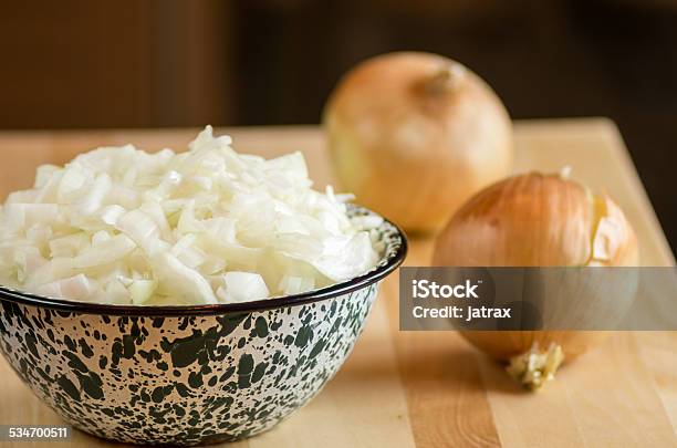 Bowl Of Chopped Onions On Cutting Board Stock Photo - Download Image Now - 2015, Bowl, Cutting Board