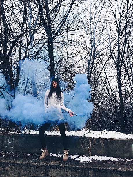 istock Girl holding smoke blue bomb 534700671