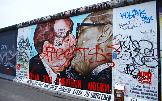 Berlin, Germany - November 10, 2013: Fragment of East Side Gallery in Berlin, Germany. It's a 1.3 km long part of original Berlin Wall which collapsed in 1989, and now is the largest world amateur art gallery of graffiti
