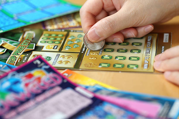 Woman scratching lottery ticket stock photo