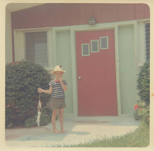 istock Vintage Photograph of a boy holding a string of fish 534703065