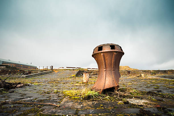 The Derelict Graving Docks at Govan, Glasgow A rusting old iron capstan amongst the overgrowth at the derelict Victorian graving docks - a type of dry dock - in Govan, Glasgow, on the River Clyde. govan stock pictures, royalty-free photos & images