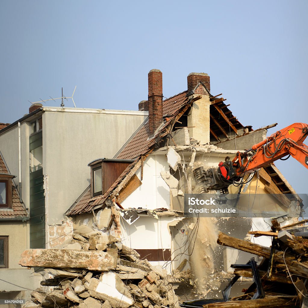 Building demolition Bulldozer crushing the building at construction site  2015 Stock Photo