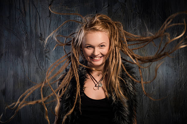istock Smiling blond woman with fluttering dreadlocks 534704925