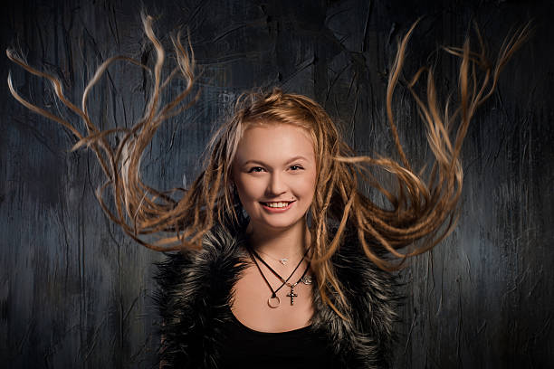 istock Smiling blond woman with fluttering dreadlocks 534704969