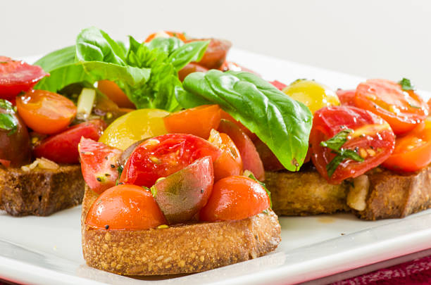 istock Fresh bruschetta with mixed tomatoes cheese and basil on plate 534705901