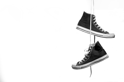 Hanging Pair of Black and White Sneakers