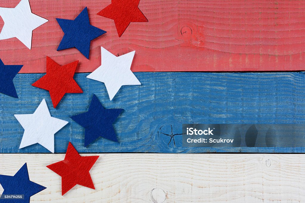 Stars on Red White and Blue Table High angle shot of red white and blue stars on a patriotic picnic table. The wood table is painted red, white and blue. Perfect for Memorial Day or 4th of July themes, with copyspace. Fourth of July Stock Photo