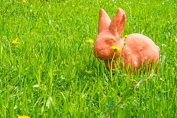 istock Easter bunny in a green meadow with dandelion flower 534715059