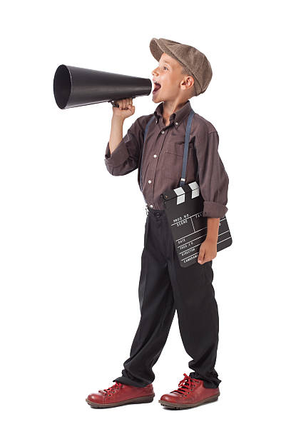 istock Mixed race little boy holding film slate and shouting 534716755