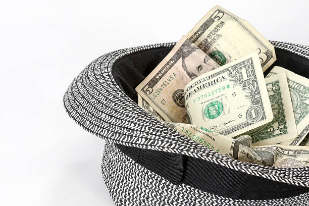 istock Passing the Hat - Black and White Hat with Cash 534717035