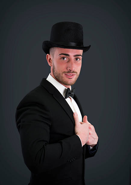istock Attractive young businessman with suit, top-hat and bowtie 534720009