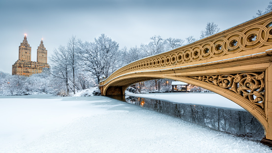 Bow Bridge in Central Park, NYC at dawn, after a snow storm