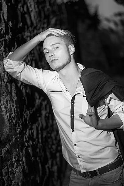 istock Handsome blond young man against stone wall at night 534737917