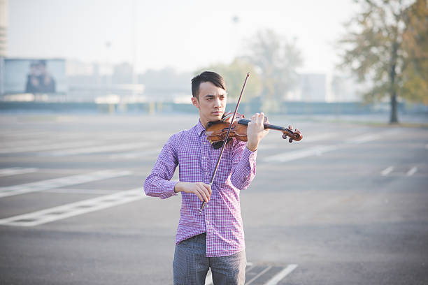 istock young crazy funny musician violinist asian man 534738891