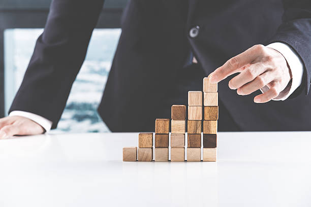 istock Closeup of businessman making a pyramid with empty wooden cubes 534738924