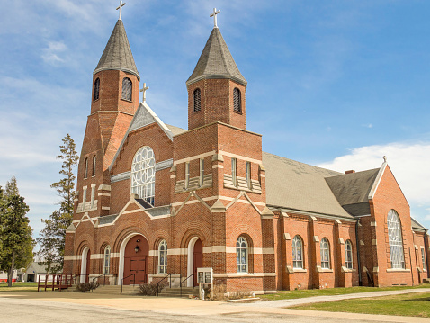Old brick Catholic church located in a small town in the Midwestern United States