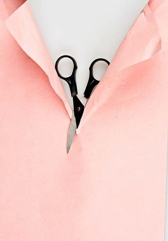 Scissors cut paper on white