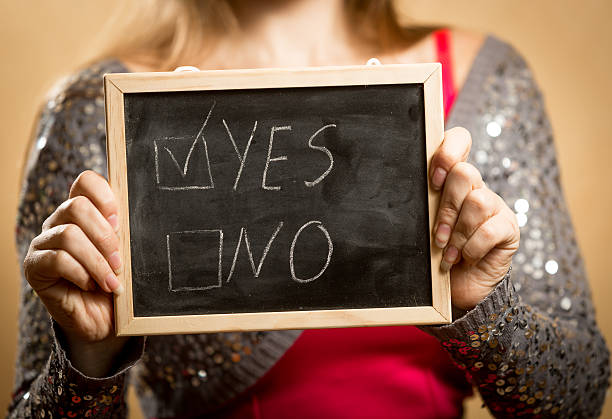 young woman holding blackboard with checked 