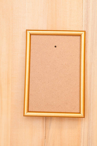 istock Empty golden picture frame on wooden background 534743679