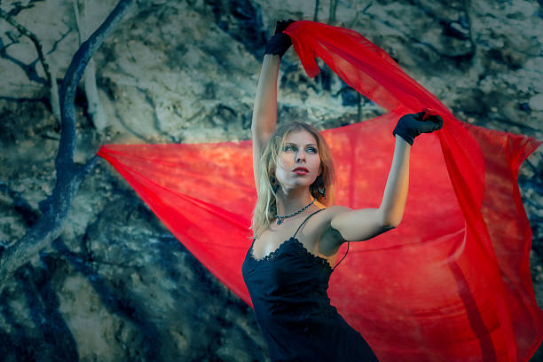 istock Beautiful Woman in the burned-down woods with Flying Red Chiffon 534744933