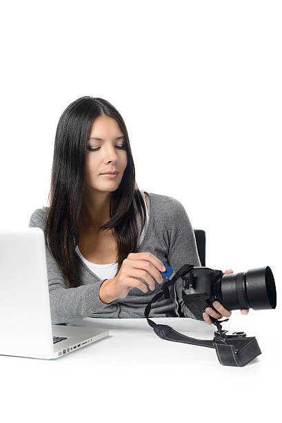 istock Female photographer inserting a card in her camera 534745017