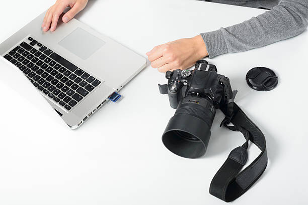 istock Photographer transferring images from a card 534745509