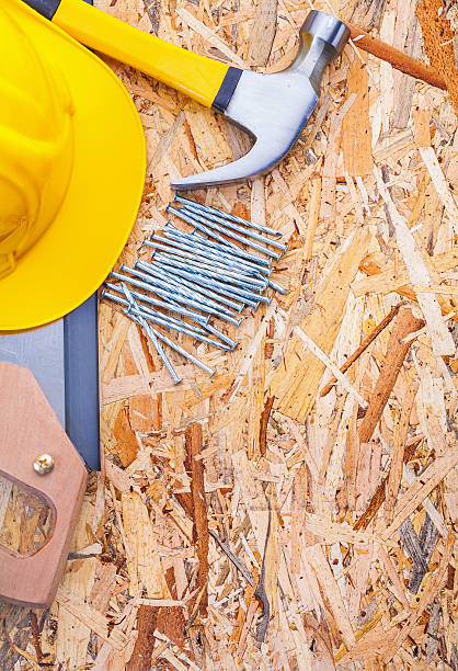 istock construction tools helmet handsaw claw hammer nails on plywood 534755507