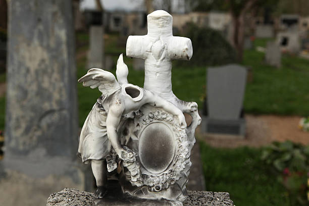 istock Headless angel. Destroyed tombstone at the abandoned cemetery. 534756735