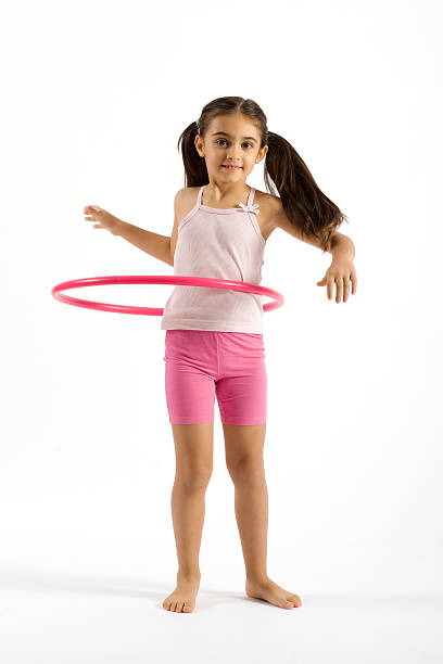 istock Young Pretty Girl Playing Hula Hoop 534757047