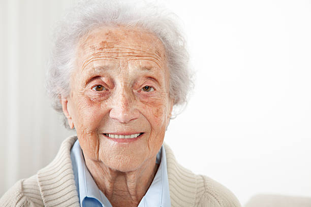 istock Senior woman sitting on a bench and looking into camera 534757351