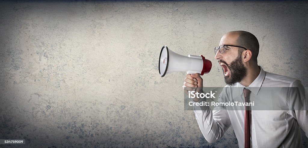 man screaming with megaphone businessman screaming news, or adult who asks a job - communication Marketing Stock Photo