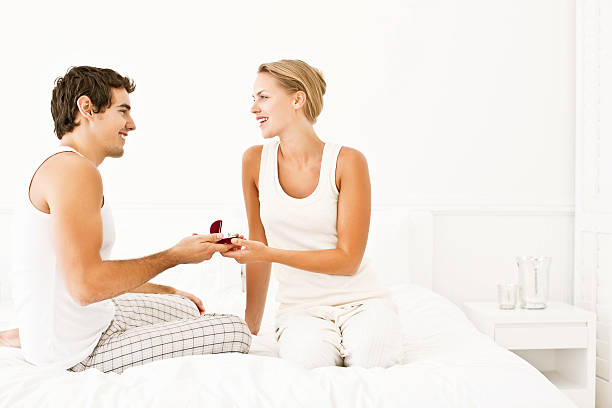 istock Cute young exchanging anniversary gifts while in bed 534759609