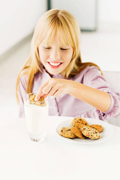 istock Young Girl Dunking a Cookie in Milk 534760041