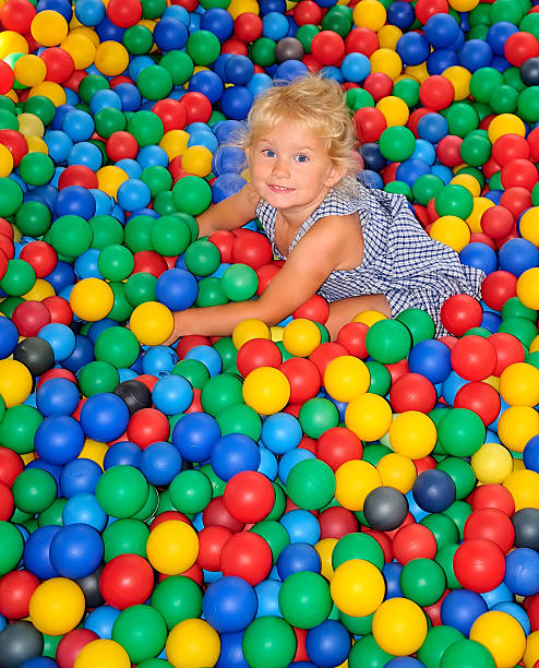 istock Happy girl playing in balls. 534760155