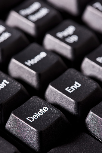 Close-up of Delete and End keys on computer keyboard. Vertical shot.