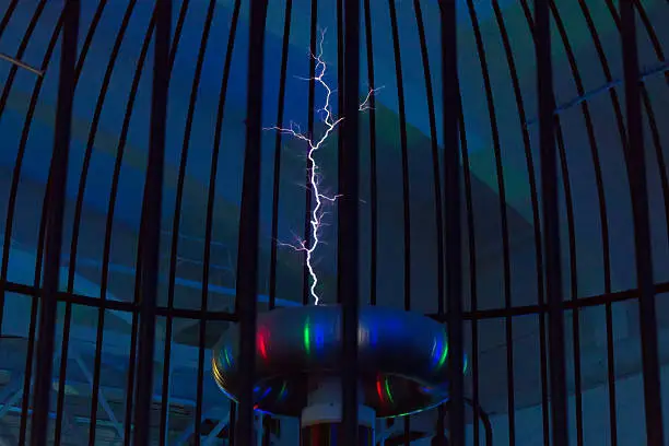 Photo of Resonant transformer in work. Tesla coil.