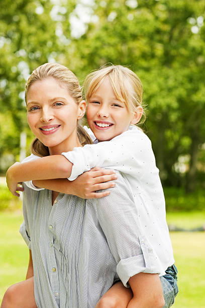 istock Cute young female piggybacking daughter while at the park 534781843