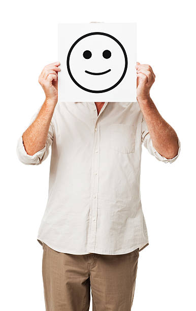istock Man Holding Placard With Smiley Face In Front Of Face 534782309